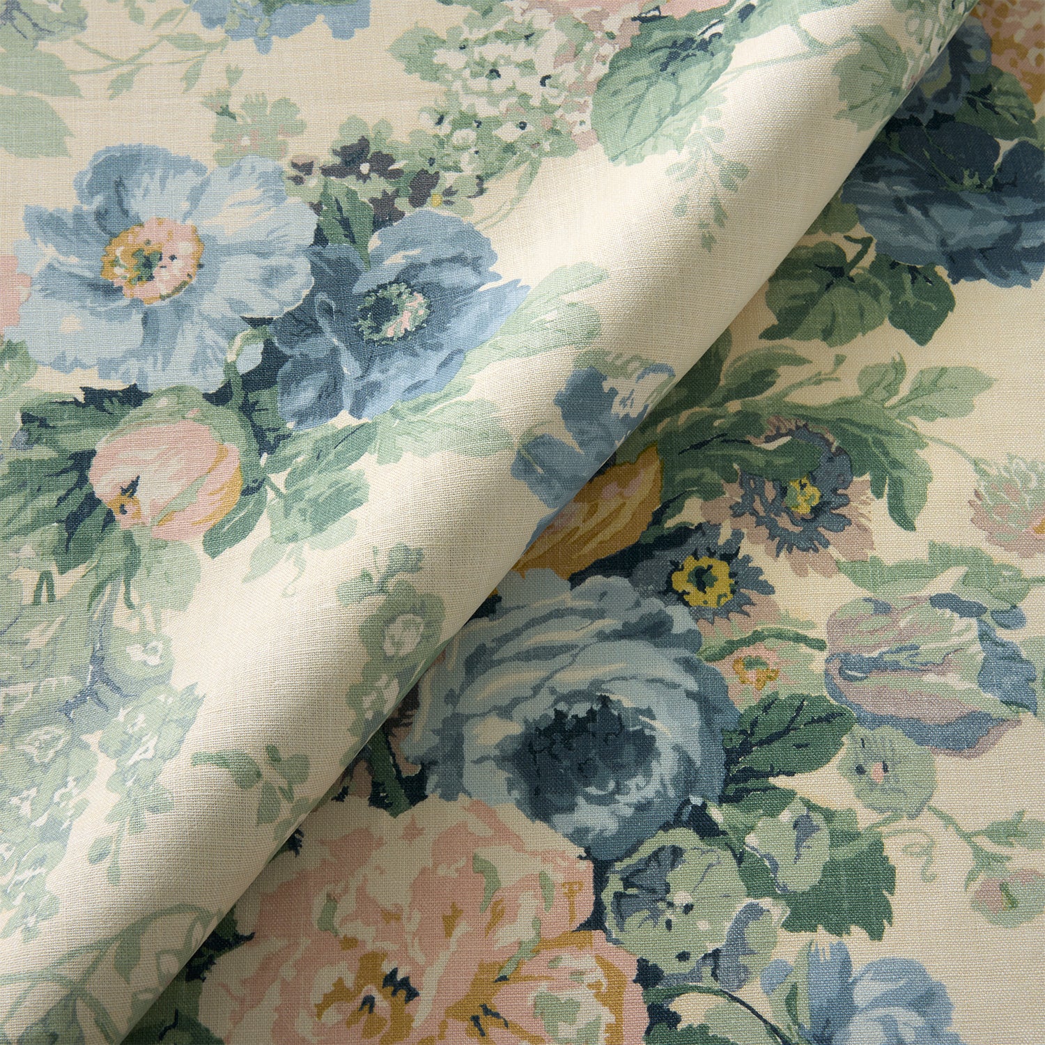 Printed linen fabric with bouquets of roses in a blue and green colourway. 