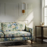 Sofa in a printed linen fabric with bouquets of roses in green and blues.