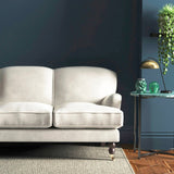 Sofa covered in a white velvet upholstery fabric