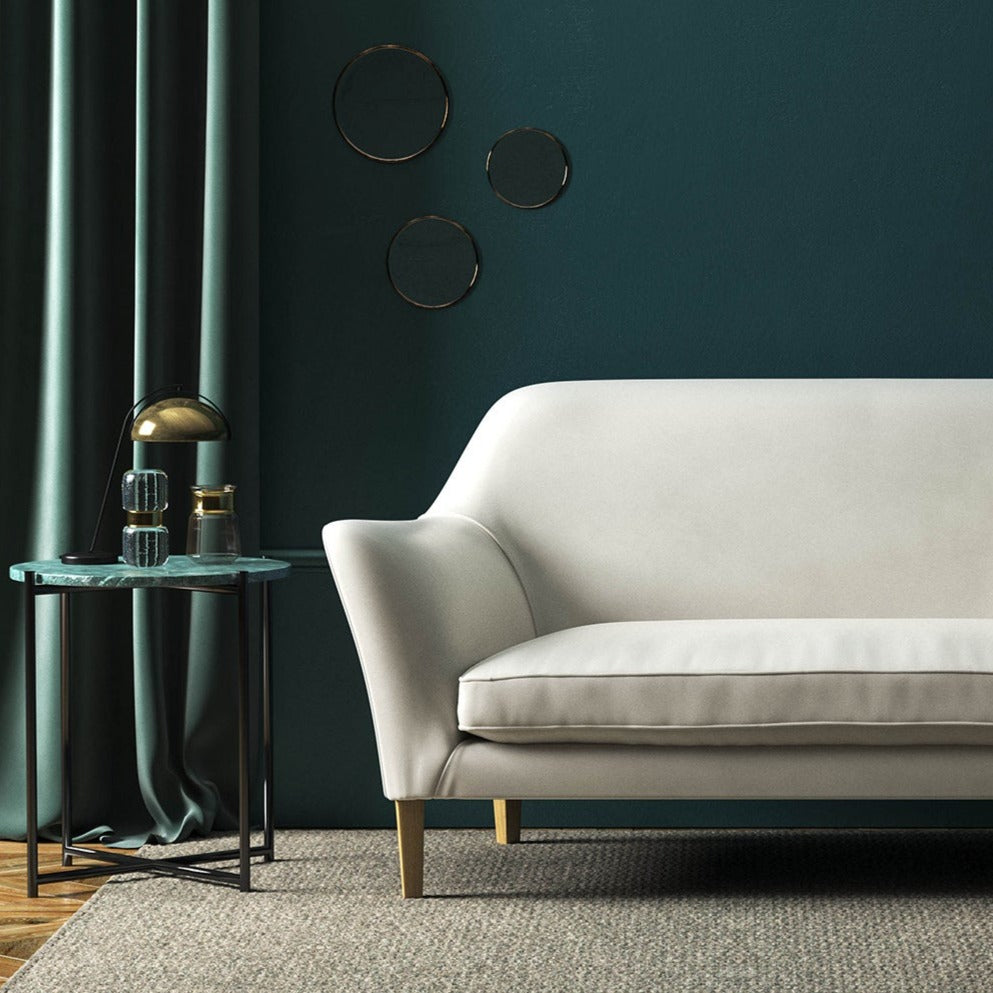 Sofa covered in a white velvet upholstery fabric 