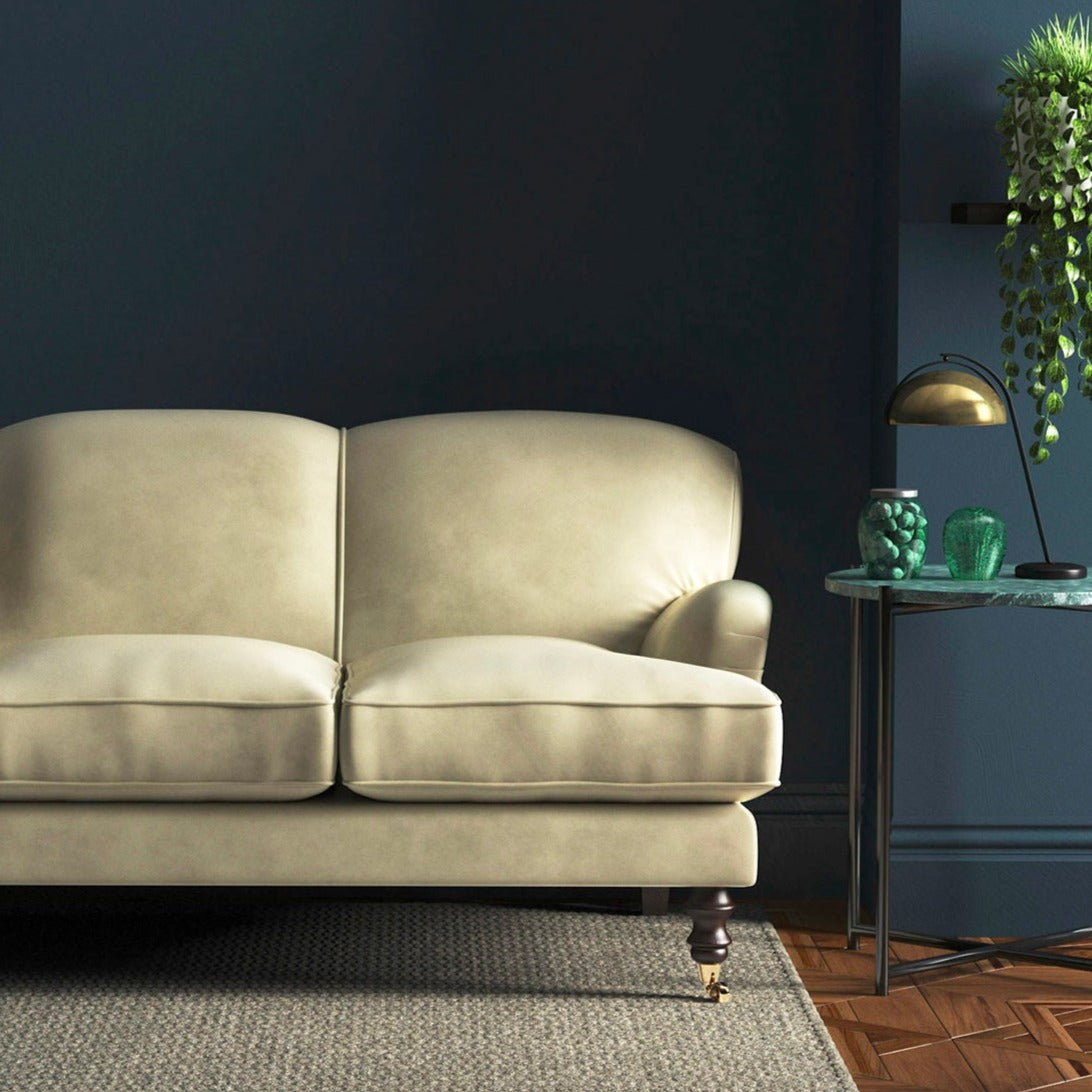 Sofa covered in a cream velvet upholstery fabric