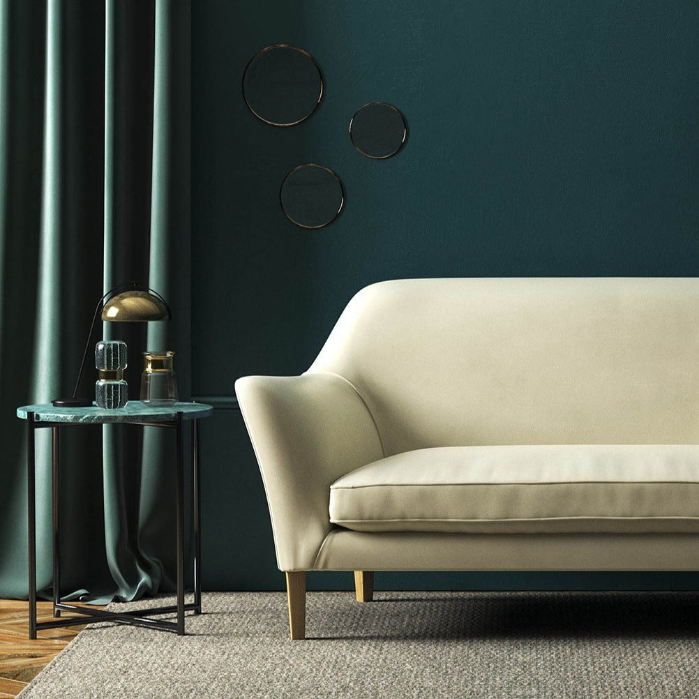 Sofa covered in a cream velvet upholstery fabric 