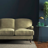 Sofa covered in a cream velvet upholstery fabric