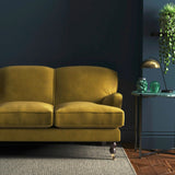 Sofa covered in a yellow velvet upholstery fabric