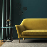 Sofa covered in a yellow velvet upholstery fabric 