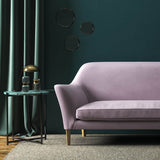 Sofa covered in a purple velvet upholstery fabric 