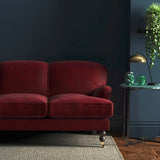 Sofa covered in a red velvet upholstery fabric