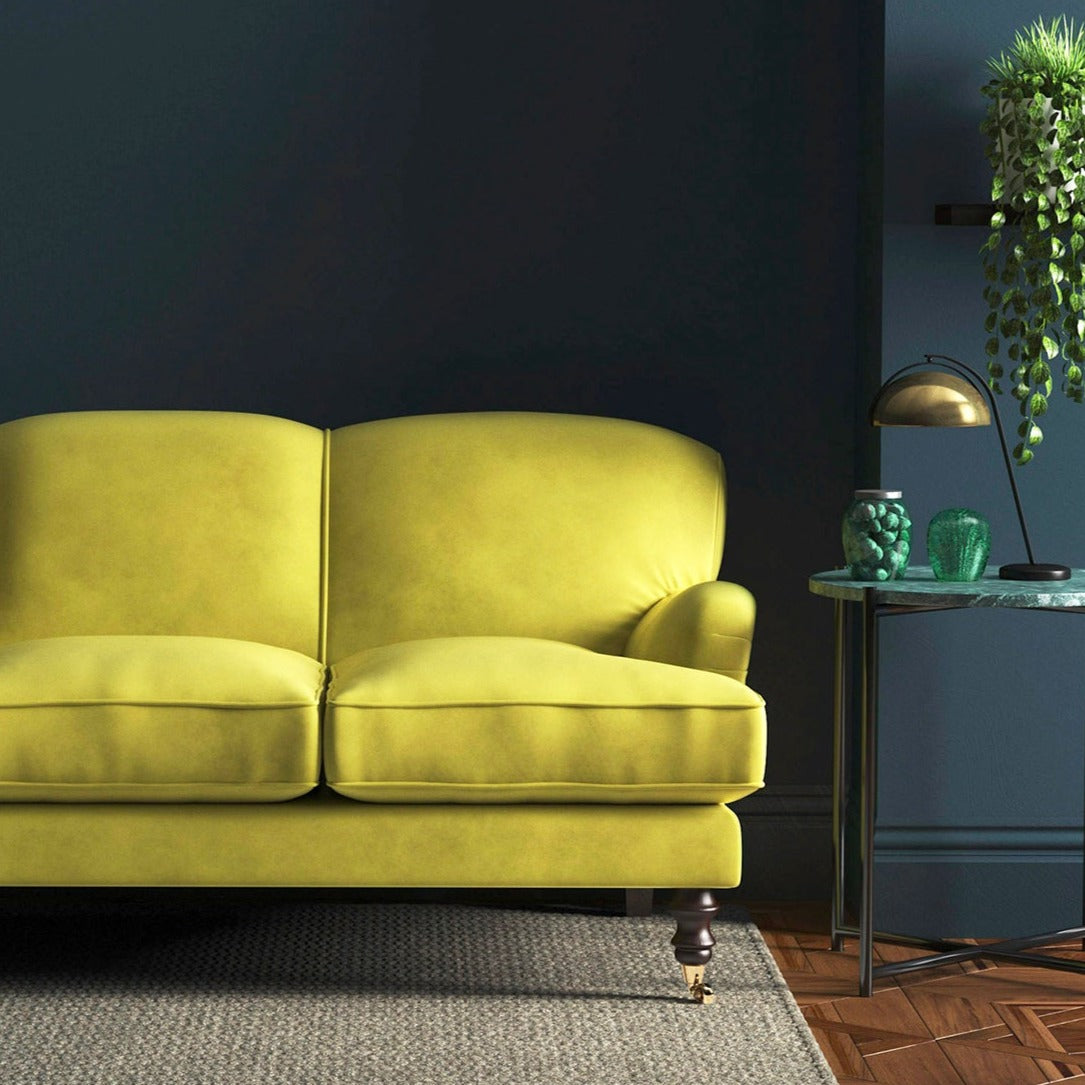 Sofa covered in a yellow velvet upholstery fabric