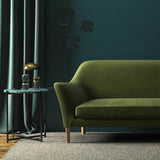 Sofa covered in a green velvet upholstery fabric