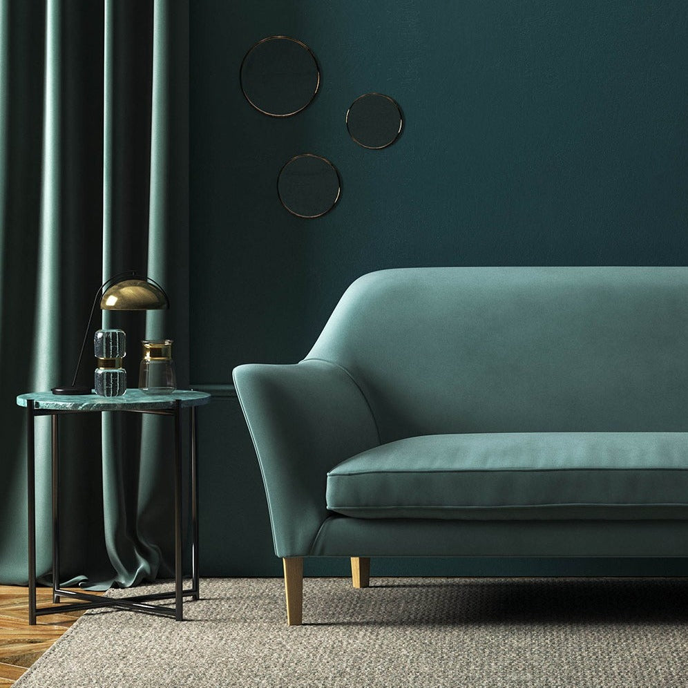 Sofa covered in a blue velvet upholstery fabric