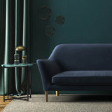 Sofa covered in blue velvet upholstery fabric 