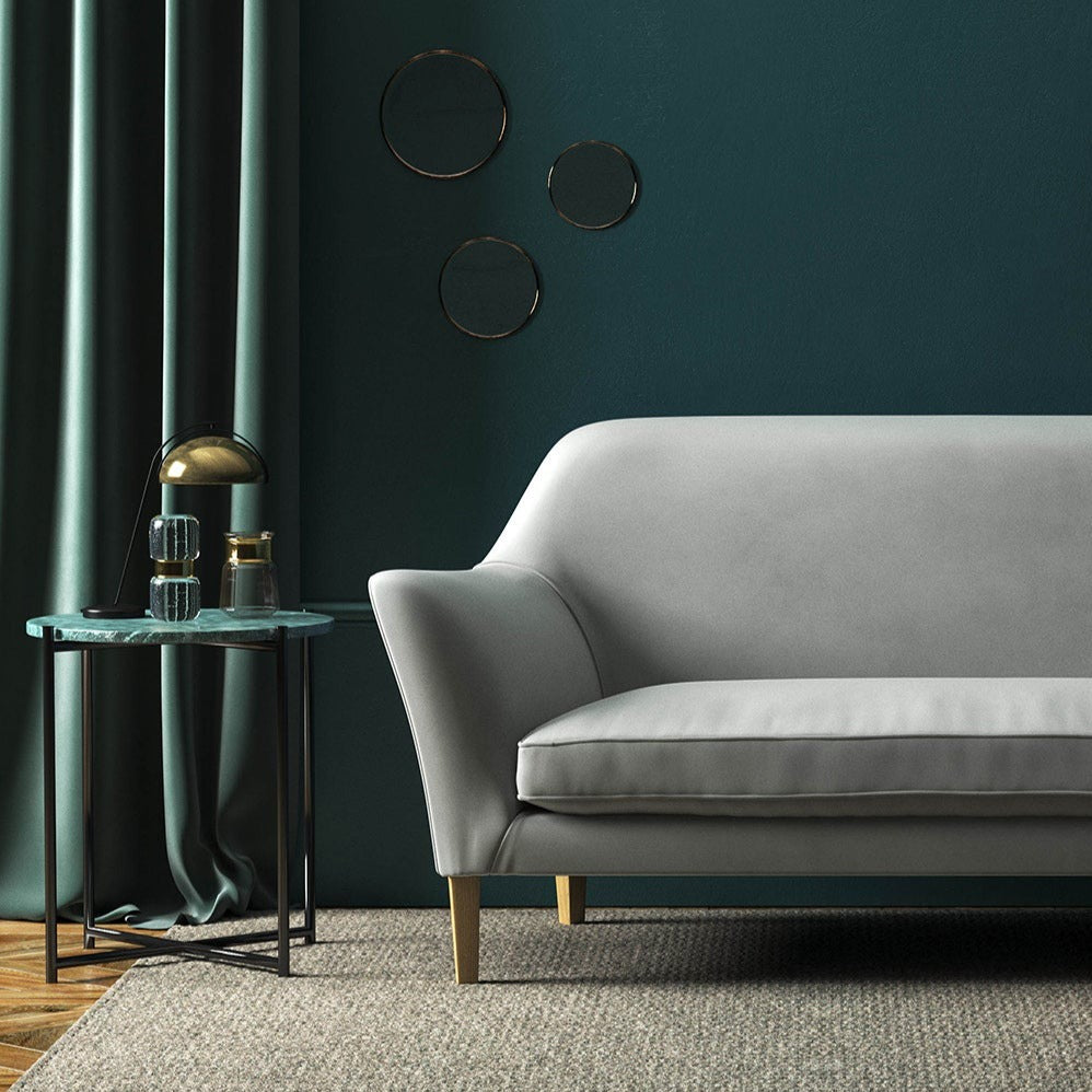 Sofa covered in a grey velvet upholstery fabric 