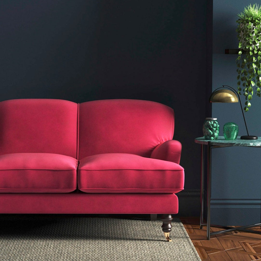 Sofa covered in a pink velvet upholstery fabric