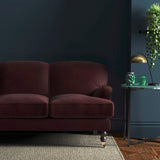 Sofa covered in a brown velvet upholstery fabric