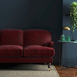 Sofa covered in a red velvet upholstery fabric