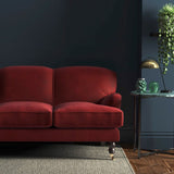 Sofa covered in a red velvet upholstery fabric
