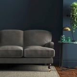 Sofa covered in a grey velvet upholstery fabric