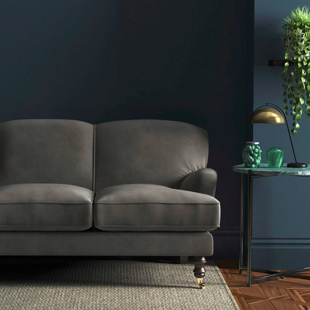Sofa covered in a grey velvet upholstery fabric