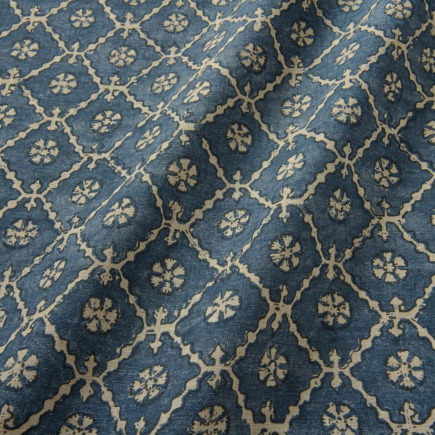 Linen fabric with a hand block-style pattern in blue, black and cream