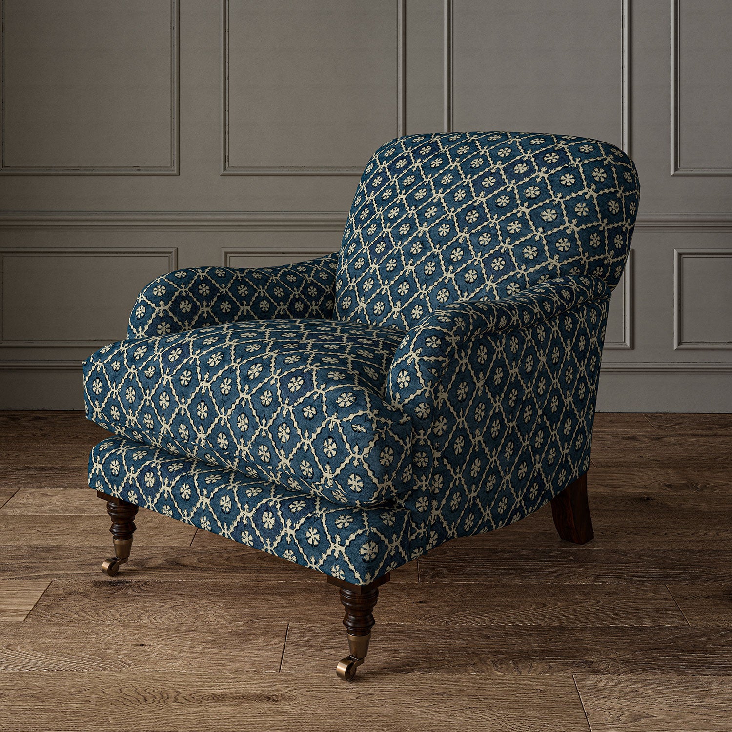Armchair covered in a linen fabric with a hand block-style pattern in blue, black and cream