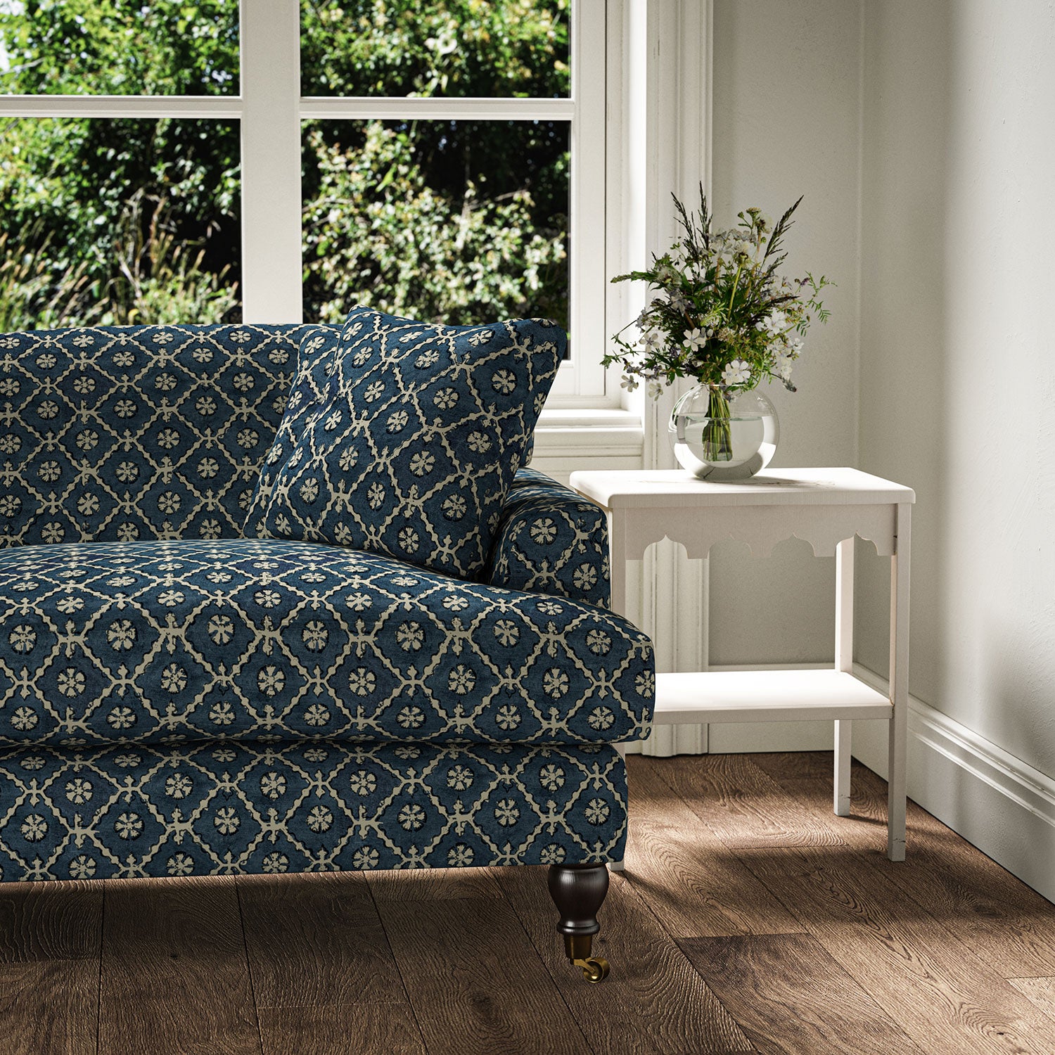 Sofa covered in a linen fabric with a hand block-style pattern in blue, black and cream