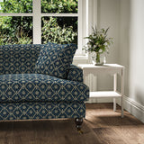Sofa covered in a linen fabric with a hand block-style pattern in blue, black and cream