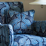 Armchair and cushion upholstered in a woven velvet in blue and cream featuring two birds.