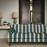 Sofa upholstered in a printed linen fabric in blue and off white, featuring a striped fern design.