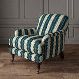 Armchair upholstered in a printed linen fabric in blue and off white, featuring a striped fern design.