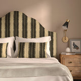 Headboard upholstered in a printed linen fabric in black and off white, featuring a striped fern design.