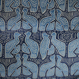 A woven velvet sample in blue and cream featuring two birds.