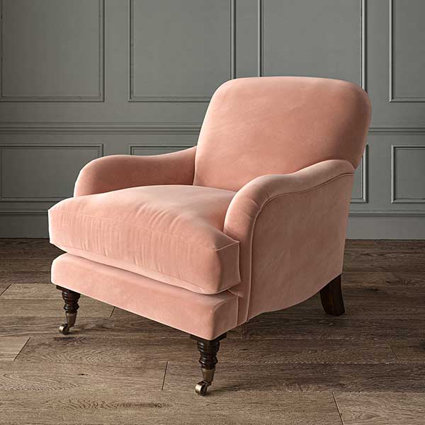 Elegant living room with blush pink velvet upholstery, neutral wood furniture, and antique brass accents, creating a warm and sophisticated space.
