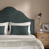 Blue headboard upholstered in a chenille woven fabric.