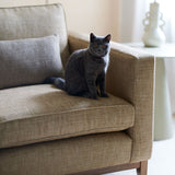 Brown chair upholstered in a chenille woven fabric with a cat on it.