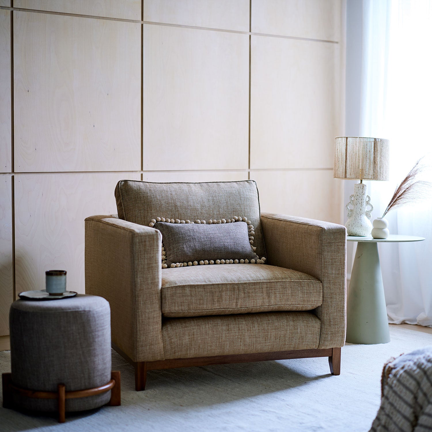 Brown chair upholstered in a chenille woven fabric.