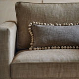 Brown chair upholstered in a chenille woven fabric.