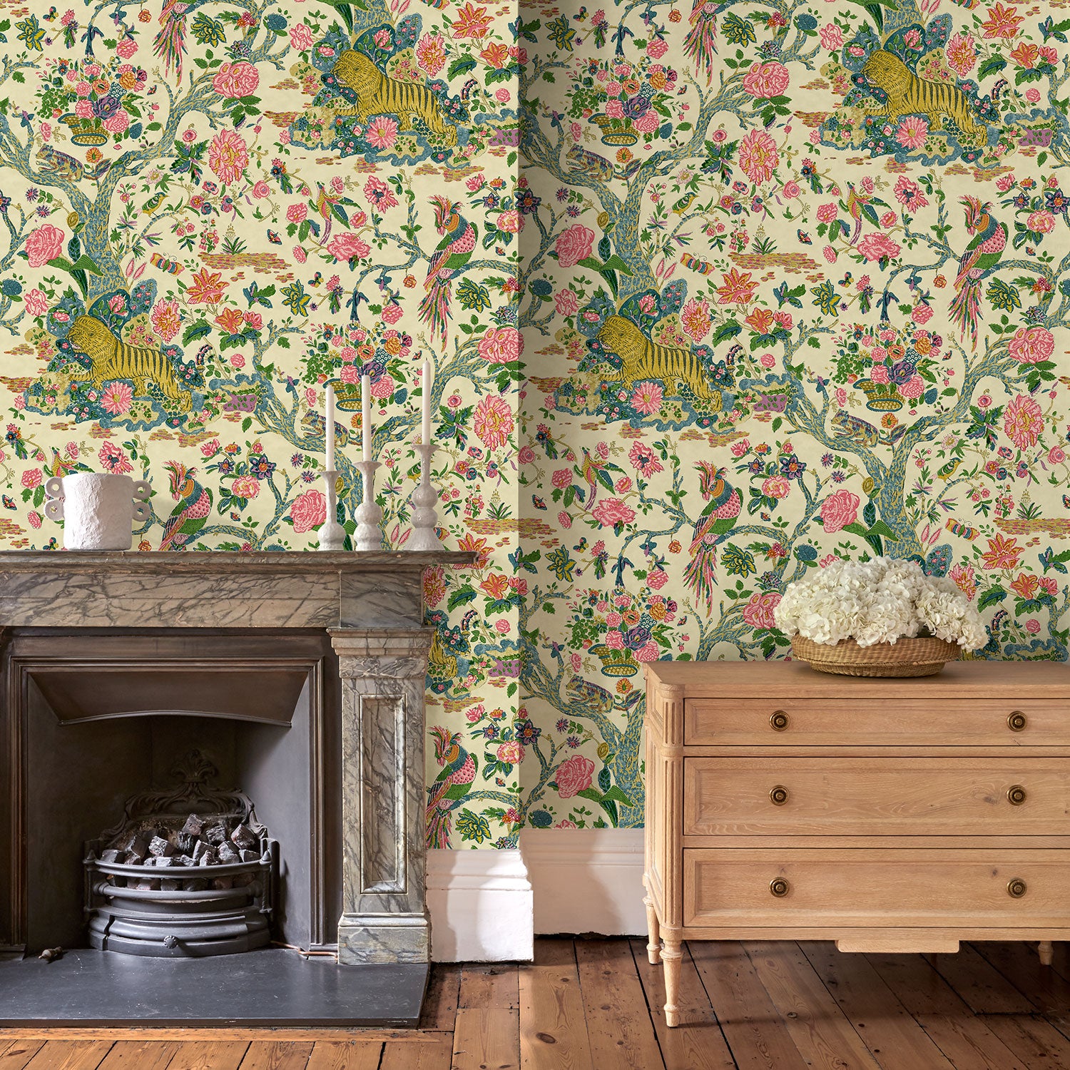 Presented in a fresh, inviting colour palette, this designer wallpaper features parrots, lions and exotic flowers.