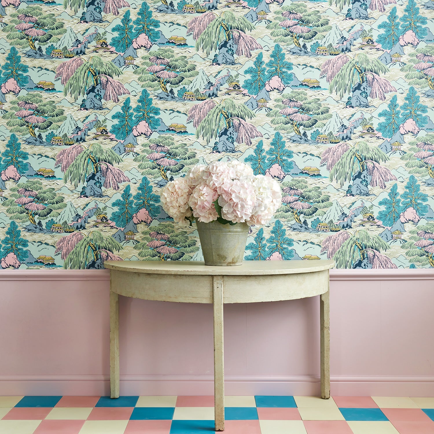Sitting room showcasing a pastel wallpaper featuring a landscape of mountains, willows and Oriental-style buildings.